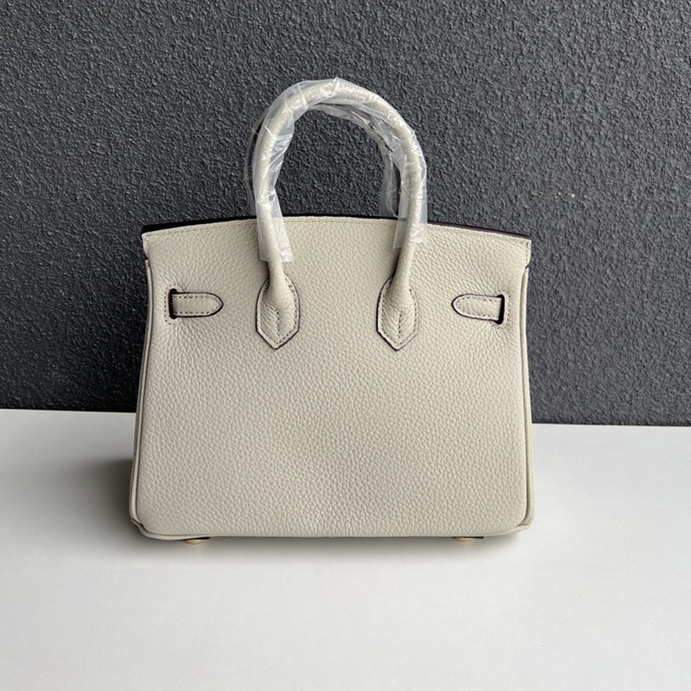 Back view of pearl gray genuine leather handbag with double rolled handles.