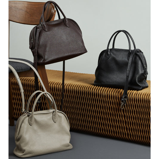 Vintage cowhide Boston handbag with top handles.