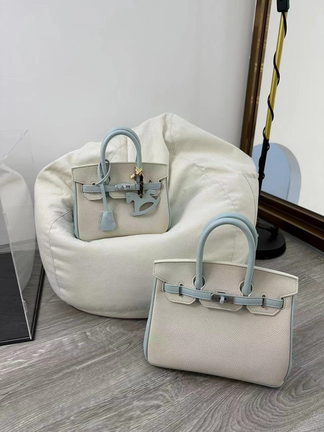 Two sizes of the bi-color Blue and White inspired Birkin handbag (mini 20 cm and small 25 cm) in premium top grain leather, featuring signature silver hardware and a matching horse charm.