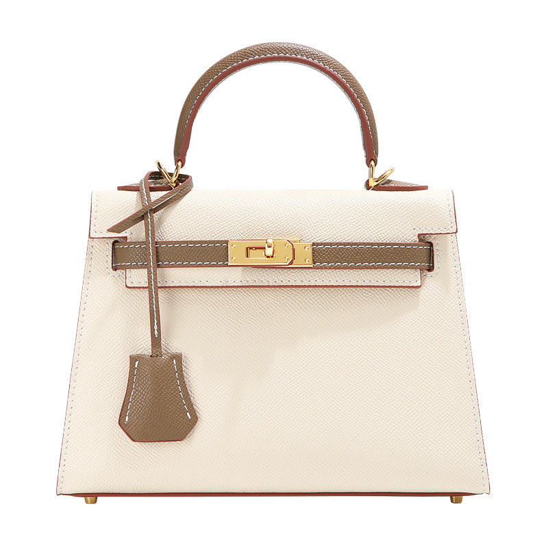 Bi-color Milk Tea Kelli handbag with signature gold-tone clasp, top handle, and matching leather clochette.