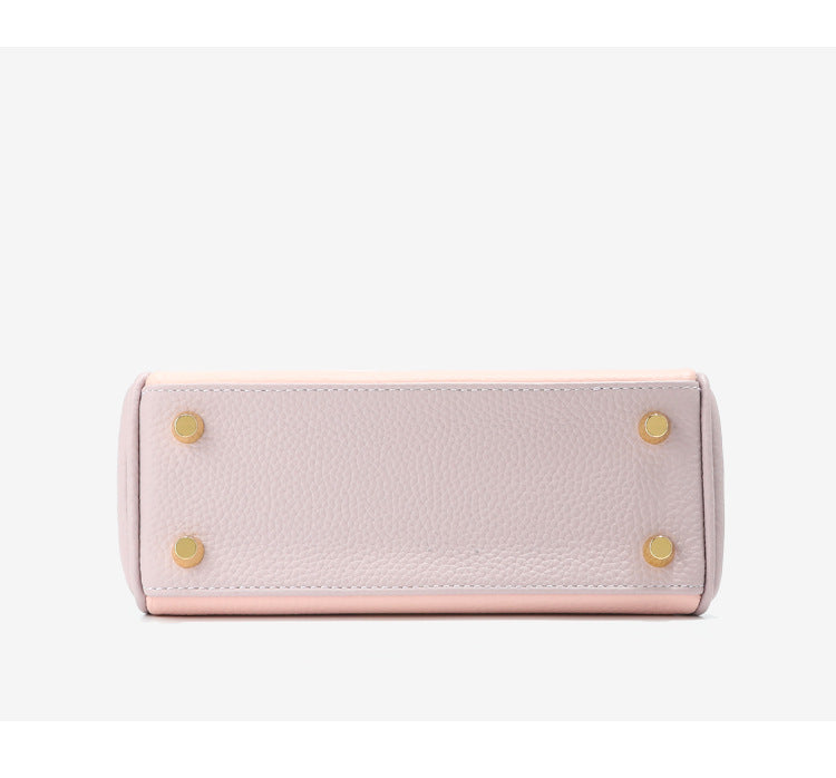 Bottom view of bi-color Pink and Light Purple mini Kelly 20 bag with gold protective feet