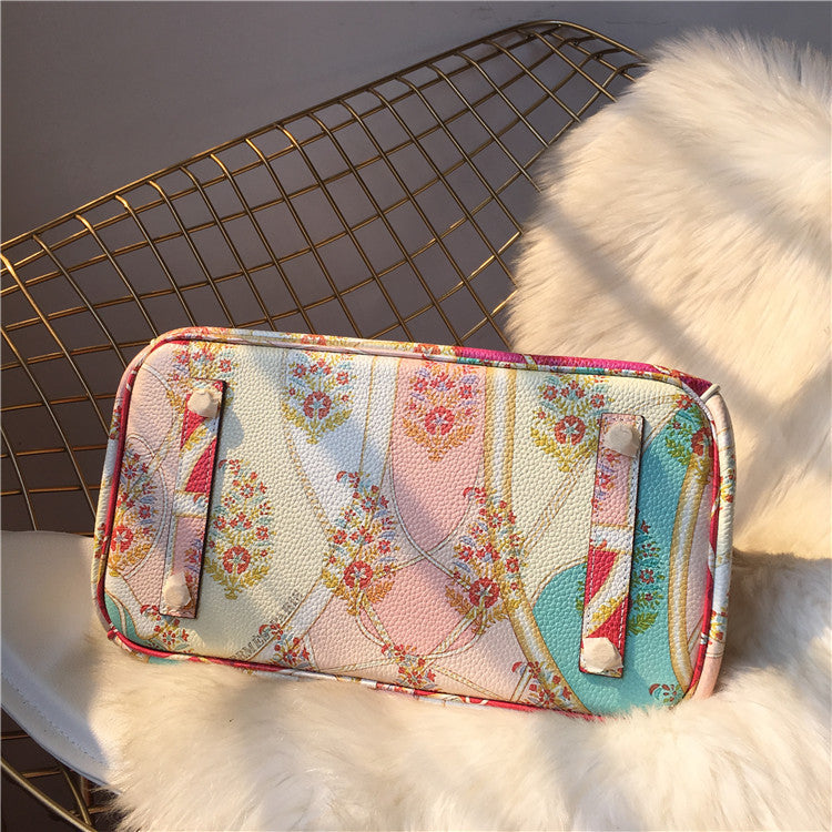 Floral patterned wallet on a textured surface with a wire basket in the background