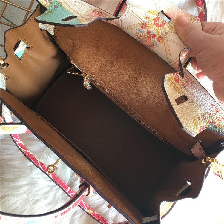 Brown leather handbag with floral patterned interior lining.