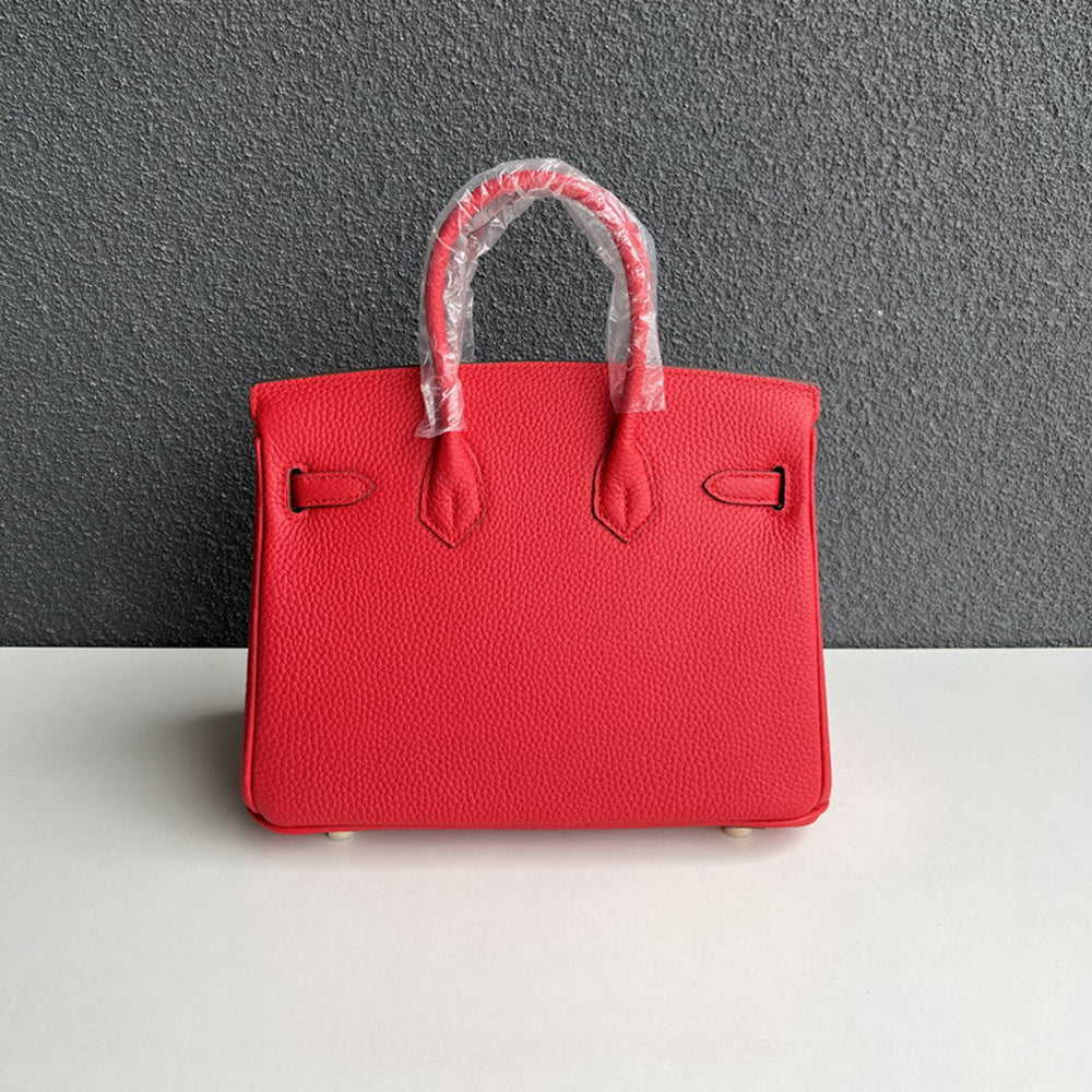 Back view of red genuine leather handbag with double rolled handles.