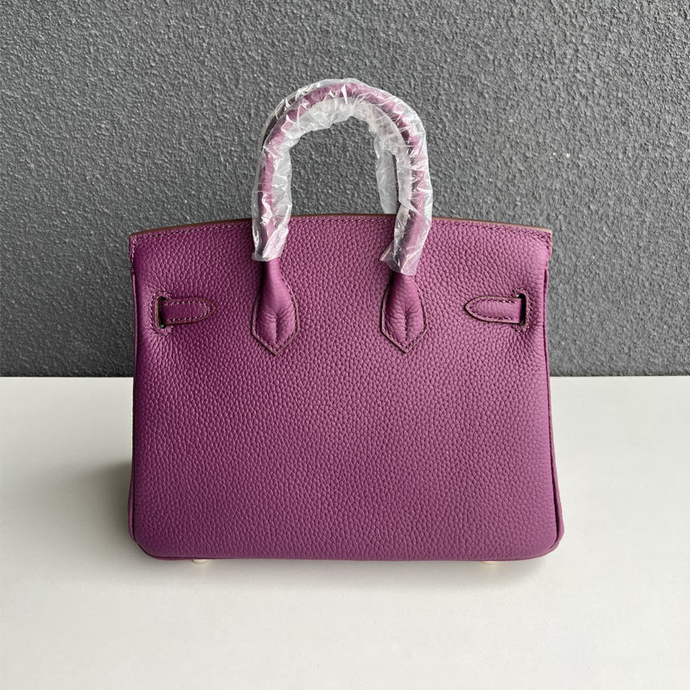 Back view of purple genuine leather handbag with double rolled handles.
