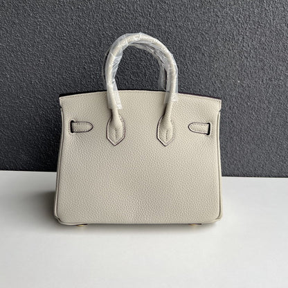 Back view of pearl gray genuine leather handbag with double rolled handles.