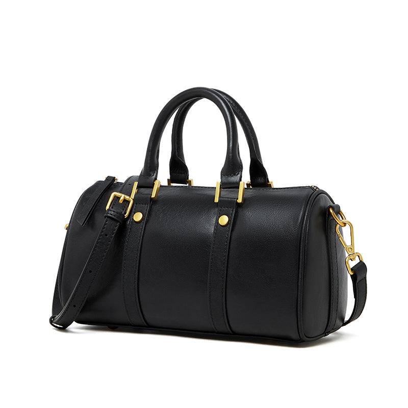 Black top grain leather Boston bag with retro design and gold hardware.