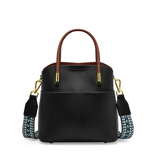 Black pebbled leather bucket bag with patterned wide strap.