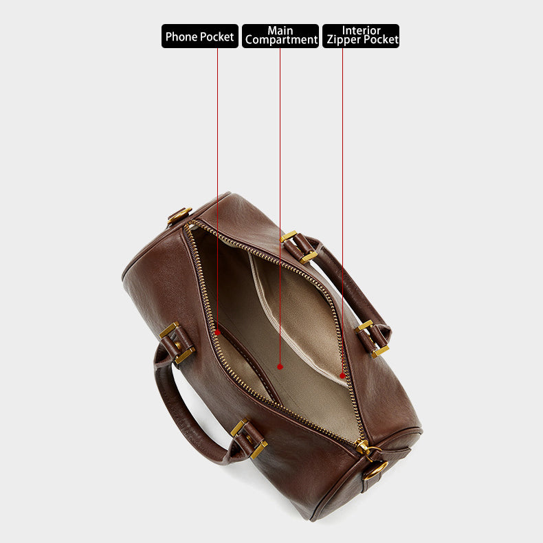 Interior view of leather Boston bag with phone pocket, main compartment, and zipper pocket.