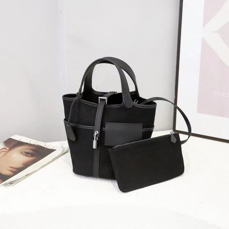 Front display of a black Cargo Pictin 18 handbag in leather and canvas with a matching pouch and silver lock hardware.