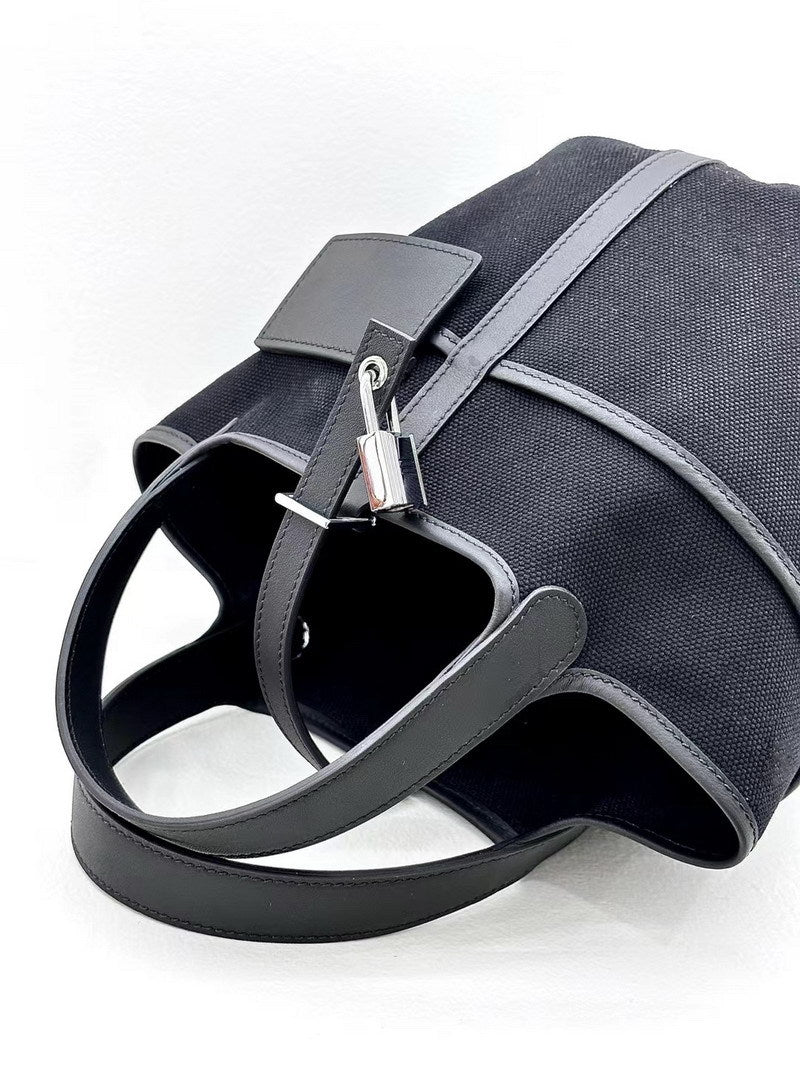 Top view of a black Cargo Pictin 18 bag showing the silver padlock closure, external pocket, and spacious interior opening.