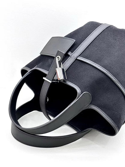 Top view of a black Cargo Pictin 18 bag showing the silver padlock closure, external pocket, and spacious interior opening.