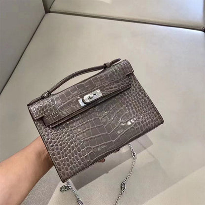 Grey crocodile embossed leather Kelli clutch bag with silver chain strap.