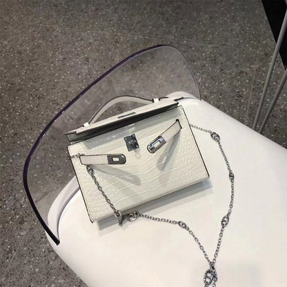 White crocodile embossed leather Kelli clutch bag with silver hardware and chain strap.