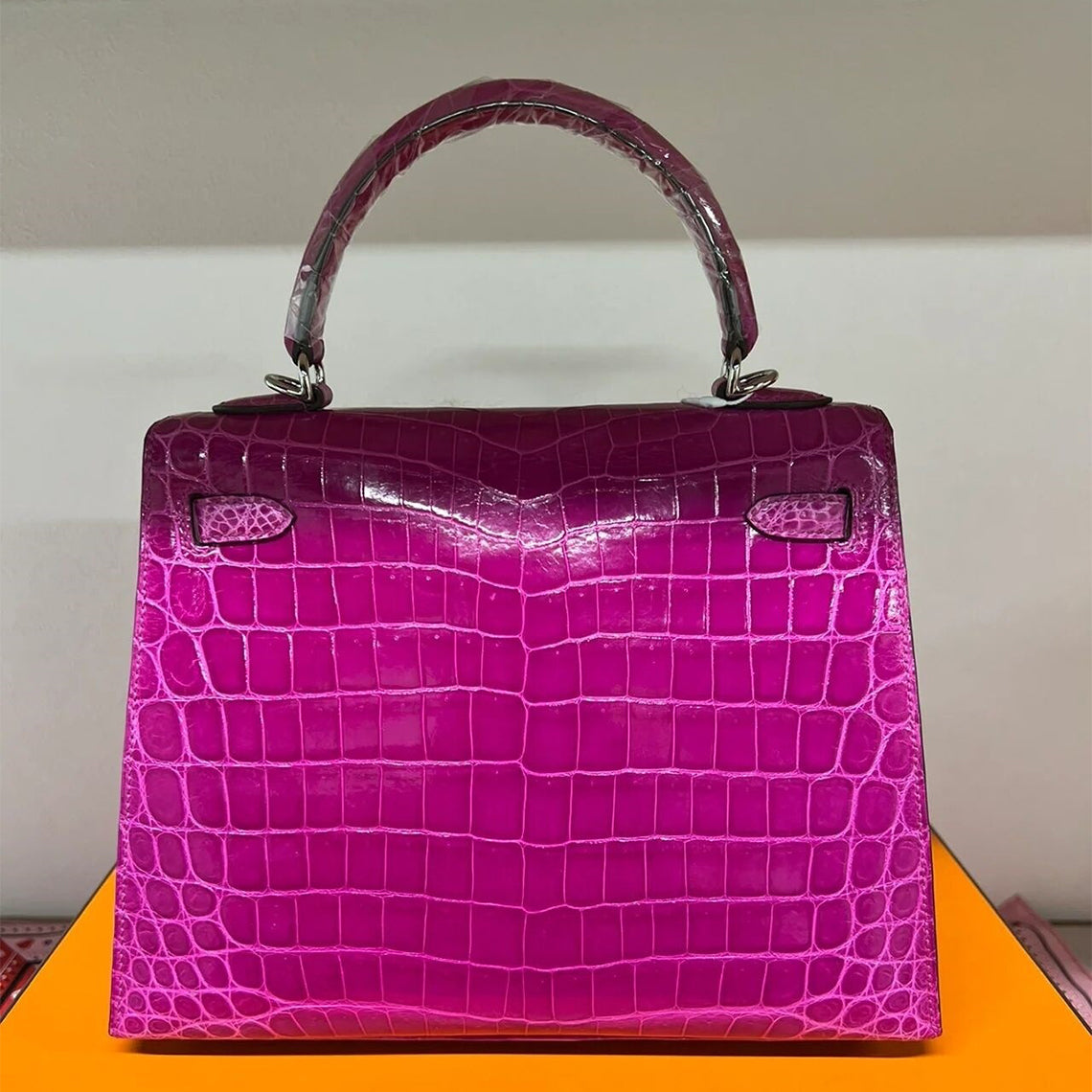 Back view of rose purple crocodile embossed leather Kelli bag with silver hardware