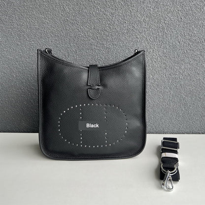 Black pebbled leather Eveline crossbody bag with silver hardware and a detachable canvas strap.