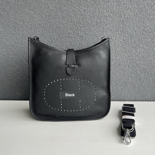 Black pebbled leather Eveline crossbody bag with silver hardware and a detachable canvas strap.