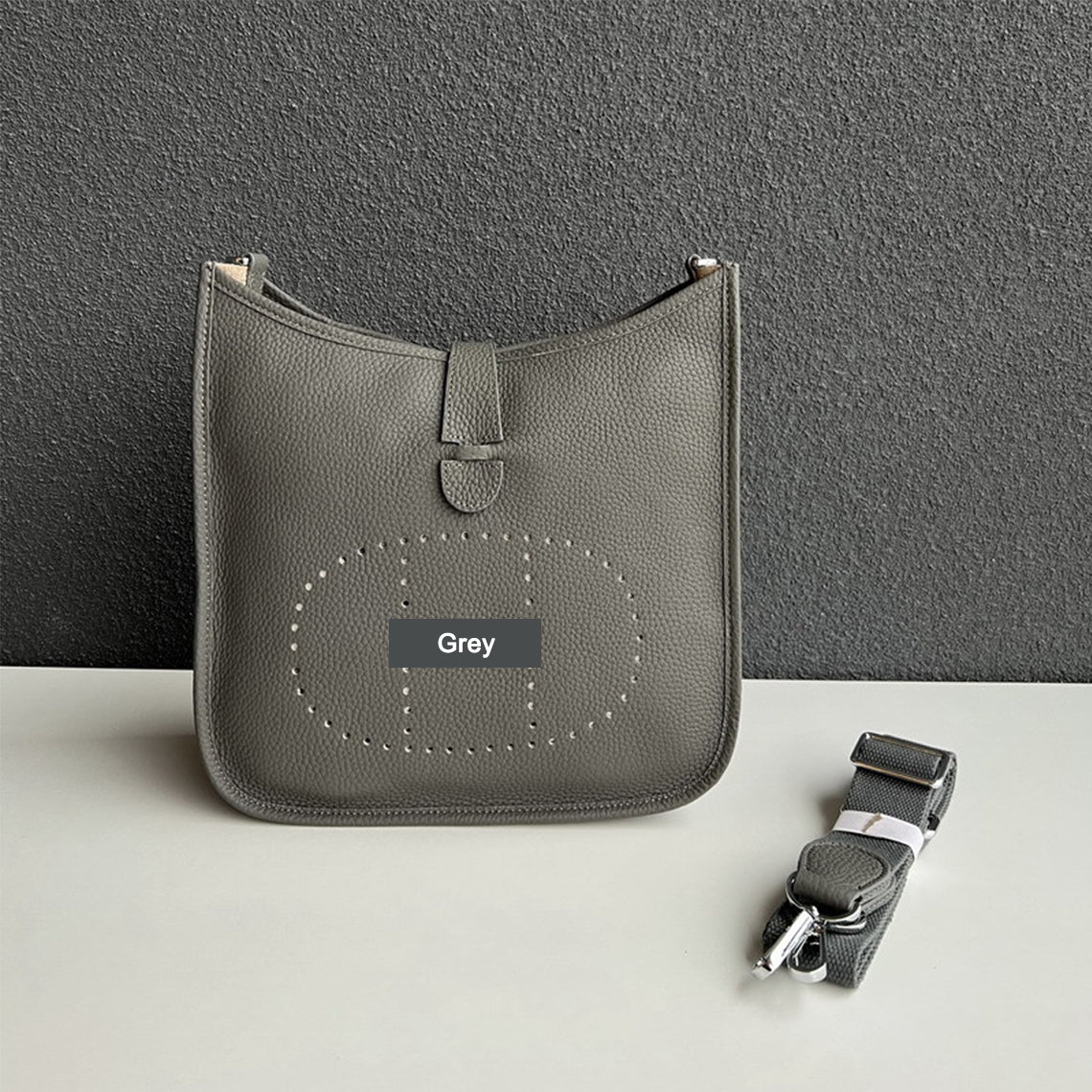 Grey pebbled leather Eveline crossbody bag with silver hardware and a matching detachable strap.