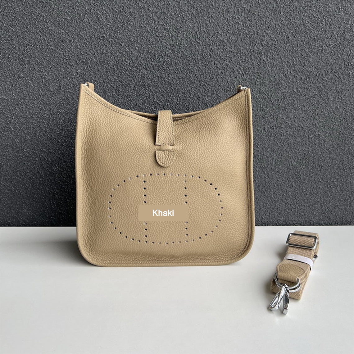 Khaki pebbled leather Eveline crossbody bag with silver hardware and a detachable shoulder strap.