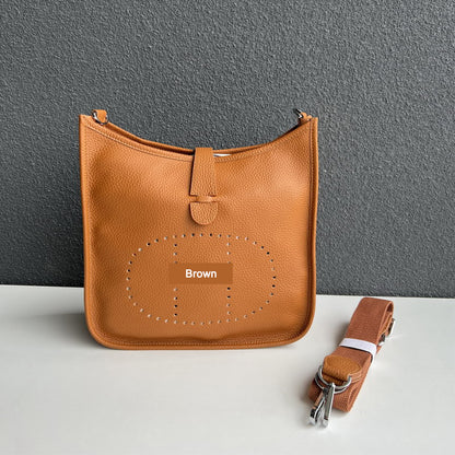 Brown pebbled leather Eveline crossbody bag with silver hardware and a matching detachable canvas strap.
