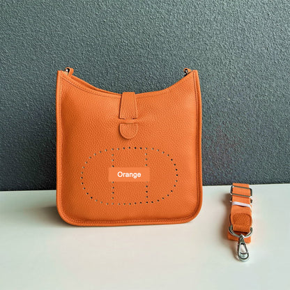 Orange pebbled leather Eveline crossbody bag with silver hardware and a matching detachable strap.