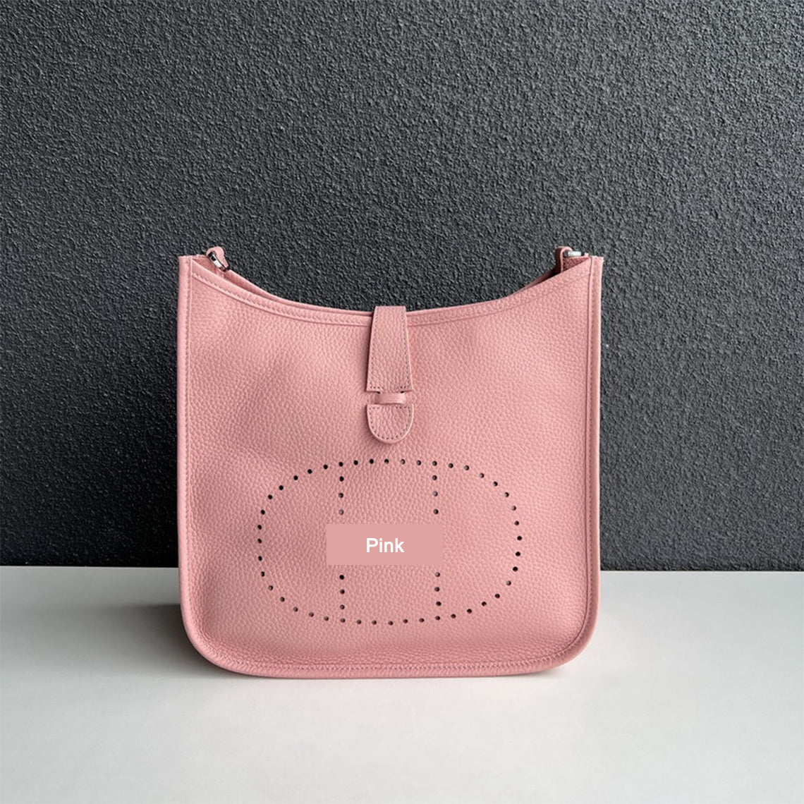 Pink pebbled leather Eveline crossbody bag with silver hardware and iconic perforated design.