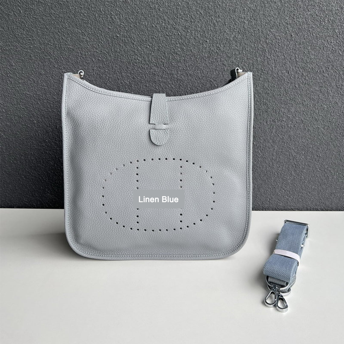 Linen Blue pebbled leather Eveline crossbody bag with silver hardware and a matching detachable strap.