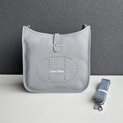 Linen Blue pebbled leather Eveline crossbody bag with silver hardware and a matching detachable strap.