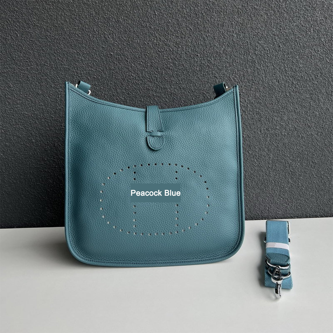Peacock Blue pebbled leather Eveline crossbody bag with silver hardware and a matching detachable strap.