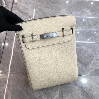 White leather designer crossbody bag with silver hardware and a canvas strap.