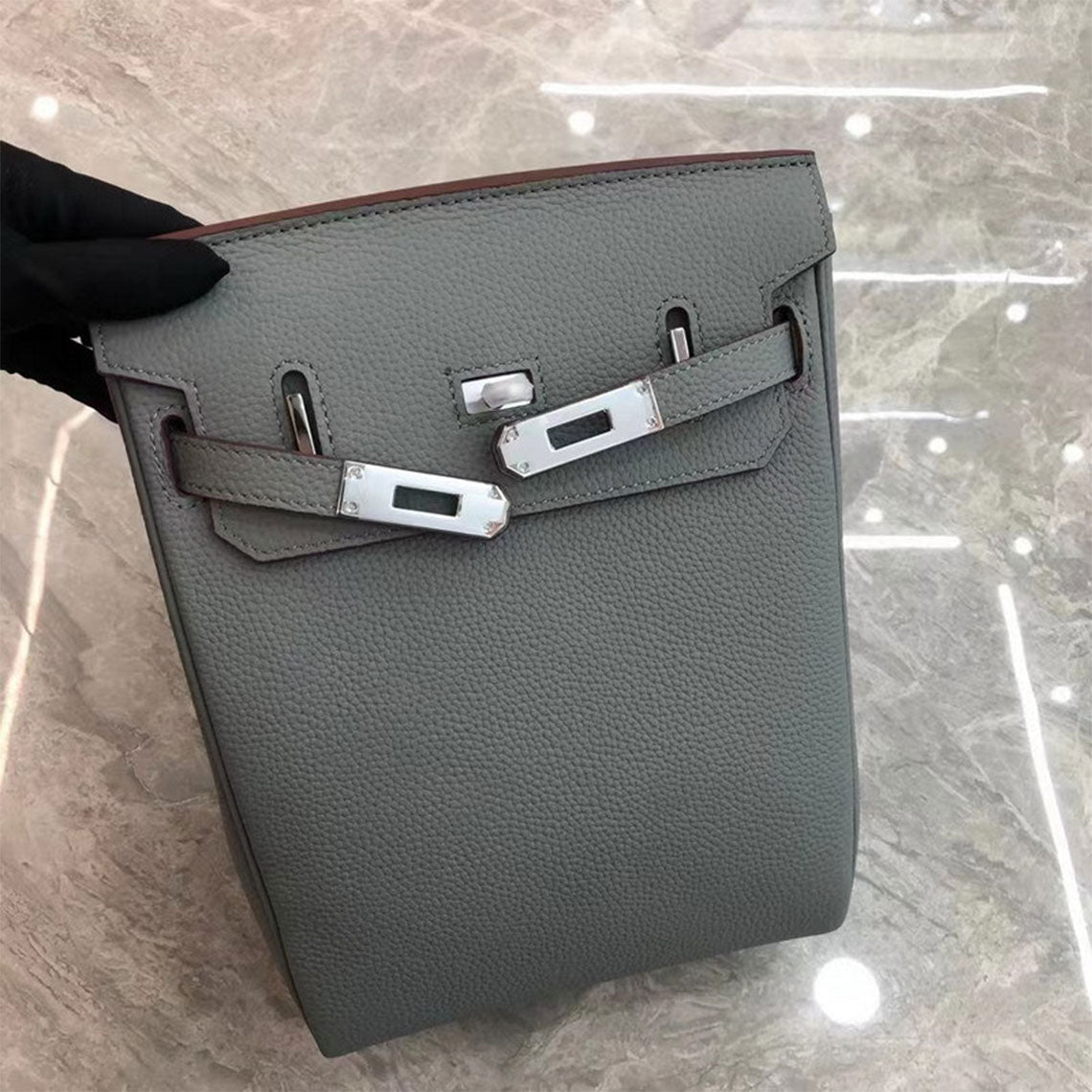 Flax Blue leather designer crossbody bag with silver hardware and a canvas strap.