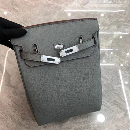 Flax Blue leather designer crossbody bag with silver hardware and a canvas strap.
