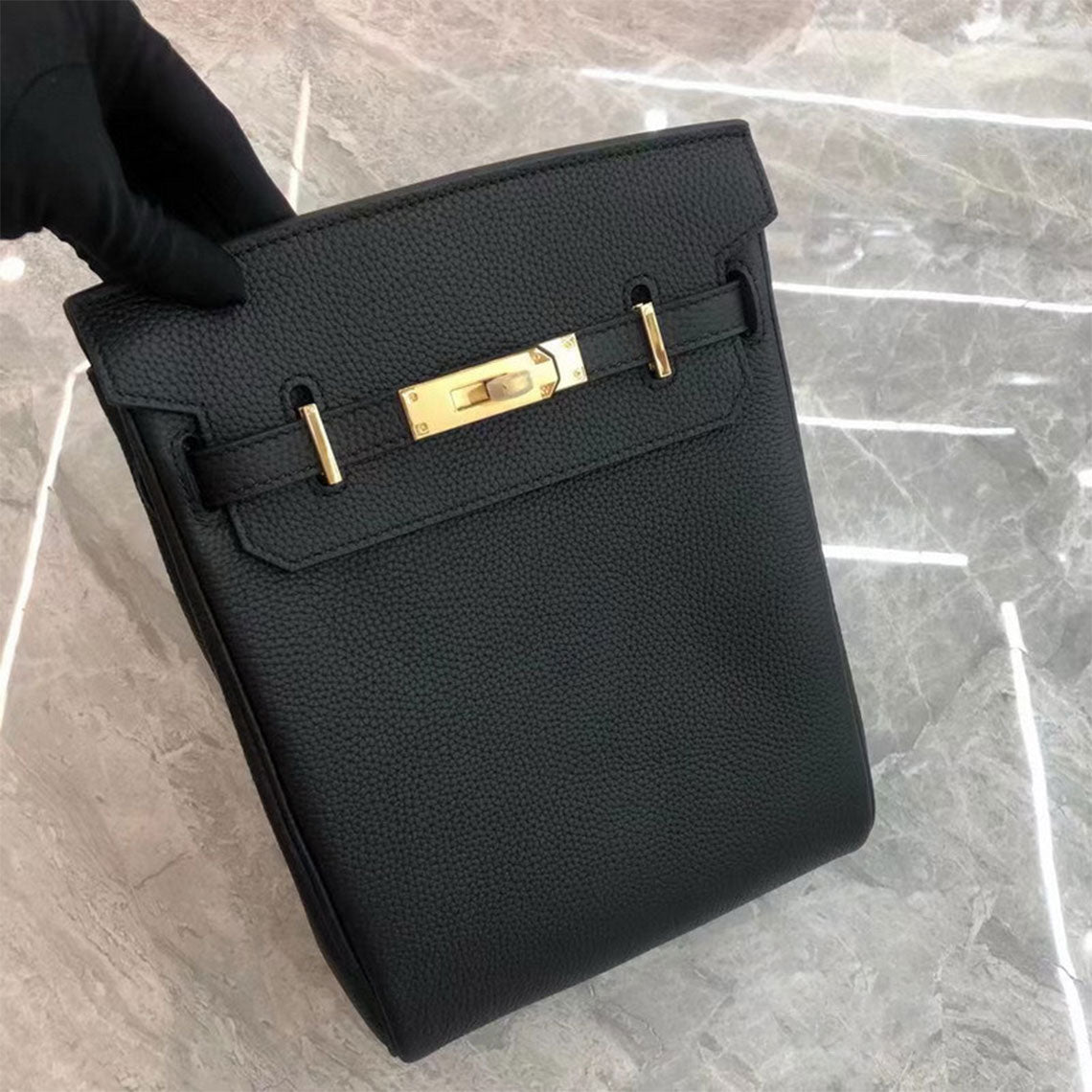 Black leather designer crossbody bag with silver hardware.