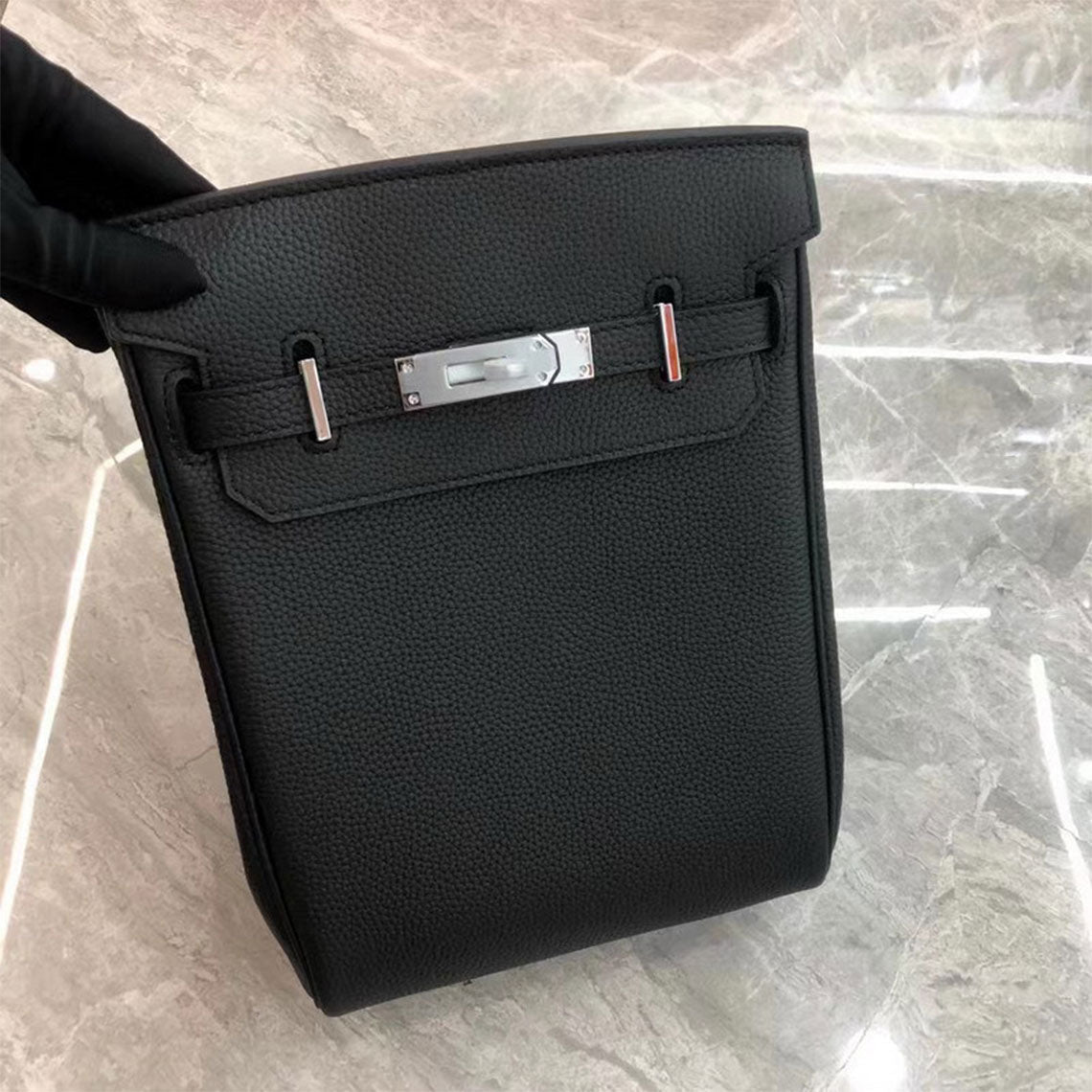 Black leather designer crossbody bag with silver hardware.