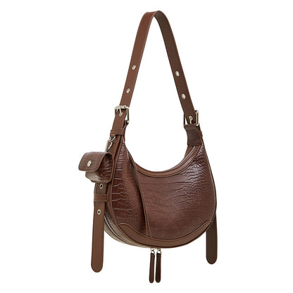 Dark brown crocodile-embossed crescent leather bag, featuring a mini pouch and tassel details.
