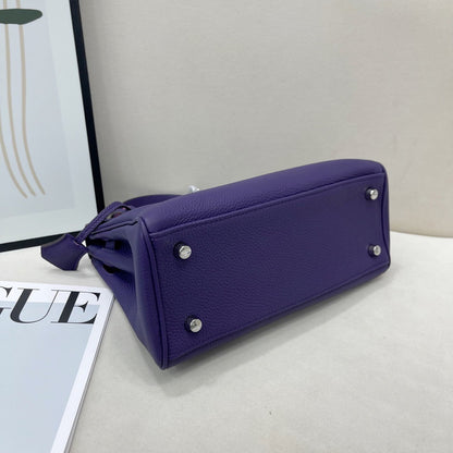 Protective studs on the base of an Anemone purple leather Kelli mini bag.