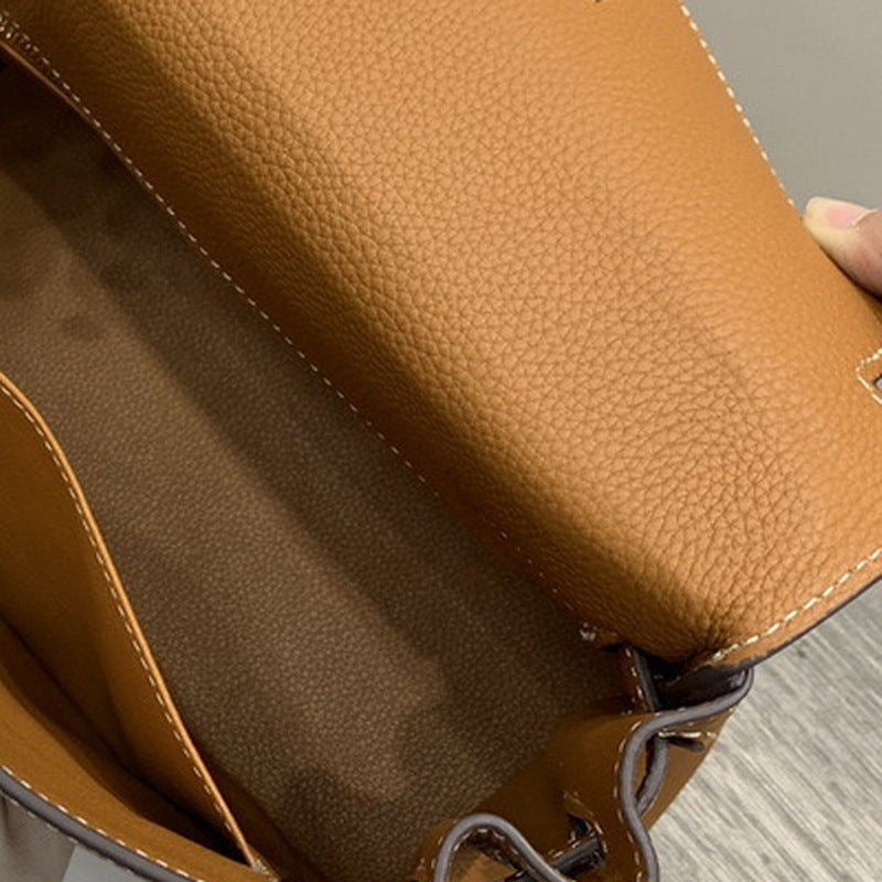Top grain leather mini Kelli bag in tan showing interior compartment and textured pebble finish.