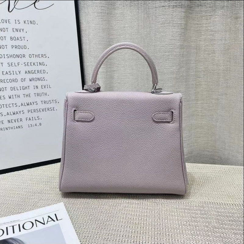 Elegant back view of a light purple mini Kelli handbag made from premium top grain pebbled leather, featuring a sleek top handle and structured silhouette.