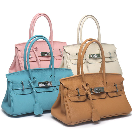 Four colors of inspired JPG Birkin handbags (pink, beige, sky blue, and tan) crafted from high-quality top grain cowhide leather with classic lock closures.