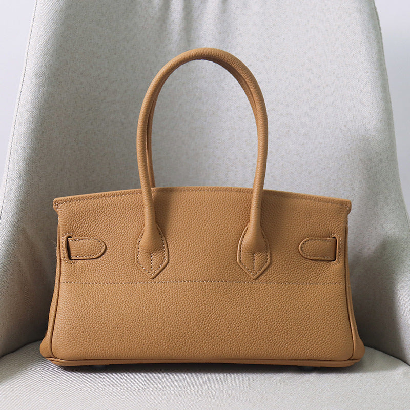 Rear view of a tan JPG Birkin inspired handbag in textured top grain cowhide leather, highlighting the clean stitching and 14 cm tall double top handles.