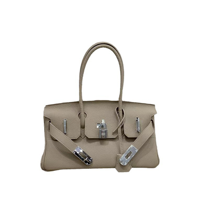 Front view of a Gray JPG Birkin inspired handbag in textured top grain cowhide leather, featuring silver-tone lock closure hardware and a matching clochette.