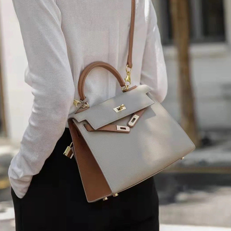 Lifestyle shot of the bi-color Kelli handbag, showcasing its size and premium leather texture.