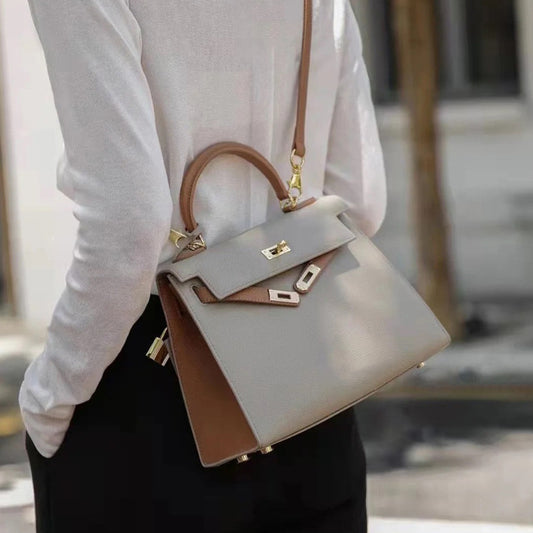 Lifestyle shot of the bi-color Kelli handbag, showcasing its size and premium leather texture.