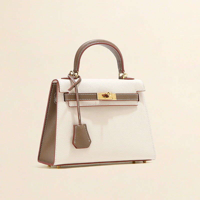 Elegant white and grey leather Kelli bag with gold-tone hardware and top-handle design.