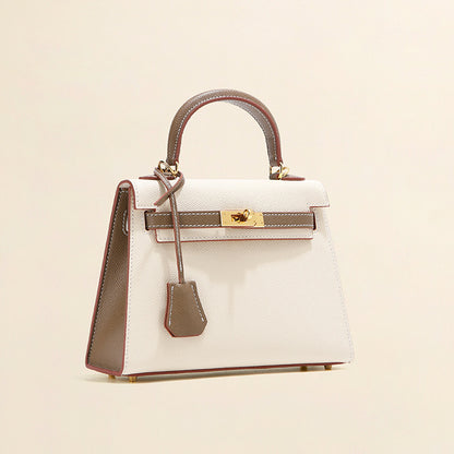 Elegant white and grey leather Kelli bag with gold-tone hardware and top-handle design.
