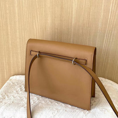 Back view of a Golden Brown top grain leather Kelli Danse bag, showing the adjustable strap threaded through leather loops for multiple carrying options.