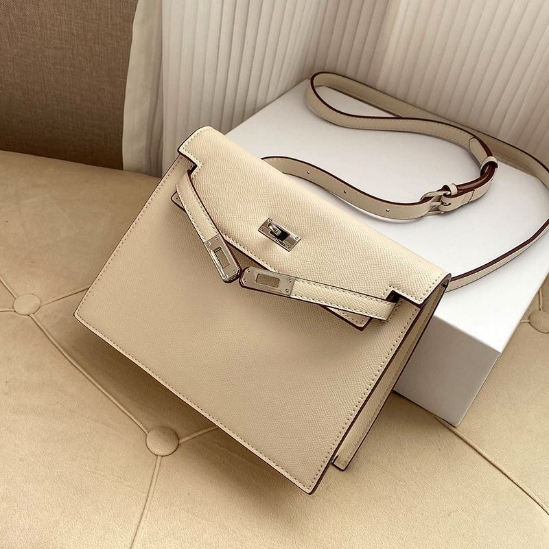 Milkshake White Epsom leather Kelli Danse bag with silver hardware and an adjustable strap, displayed on a soft cream surface.