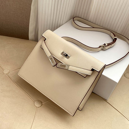 Milkshake White Epsom leather Kelli Danse bag with silver hardware and an adjustable strap, displayed on a soft cream surface.