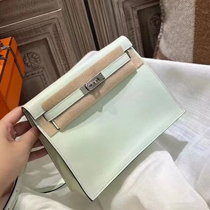 A mint green top grain leather Kelli Danse bag with silver hardware, shown in brand new condition with protective felt under the strap.