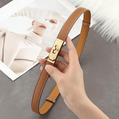 Close-up of a Golden Brown Epsom leather Kelli belt with white contrast stitching and a polished golden turn-lock hardware.